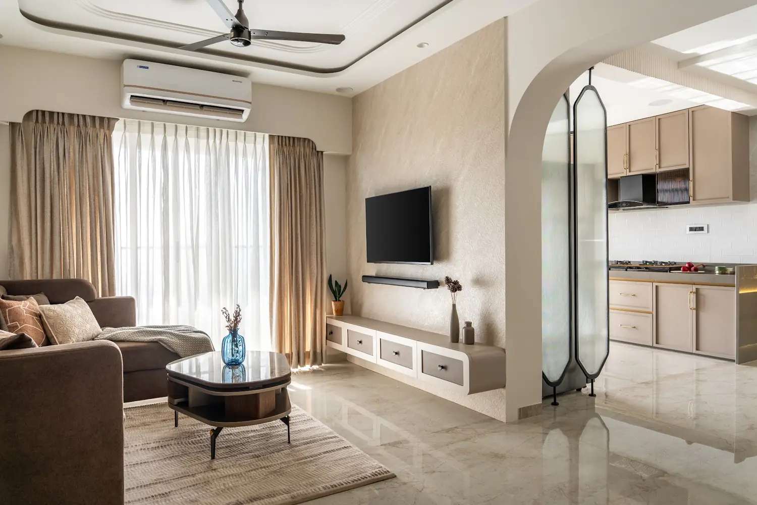 Casa Umber living room in umber wood and cream with an arched glass partition