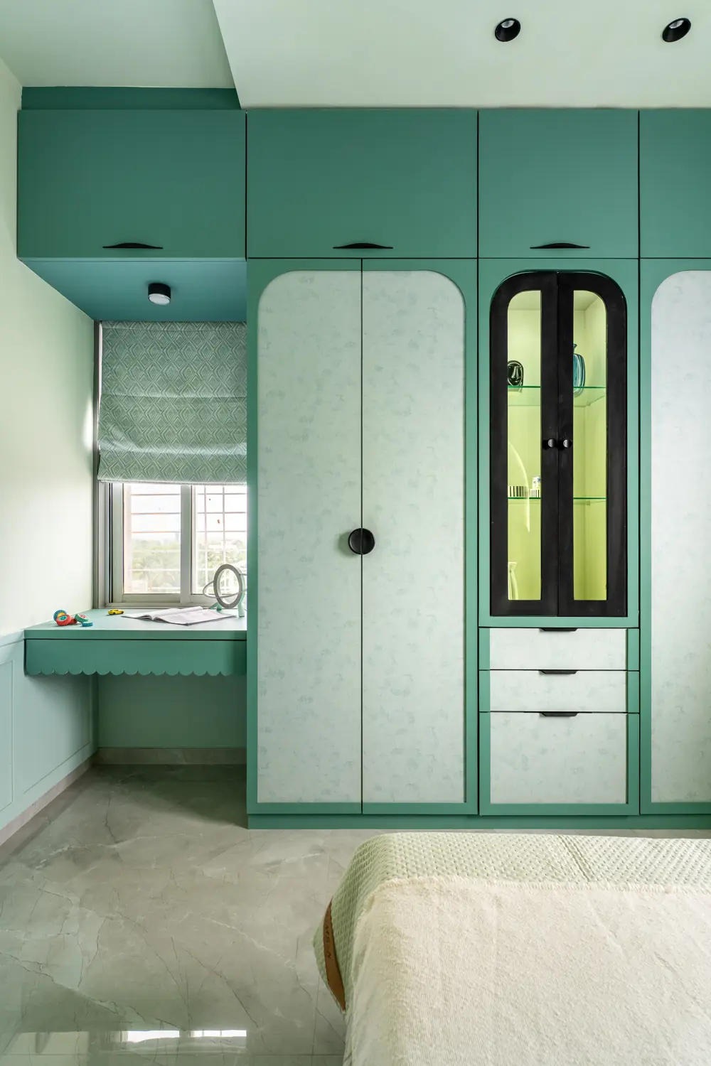 Study desk built into a sage wardrobe wall
