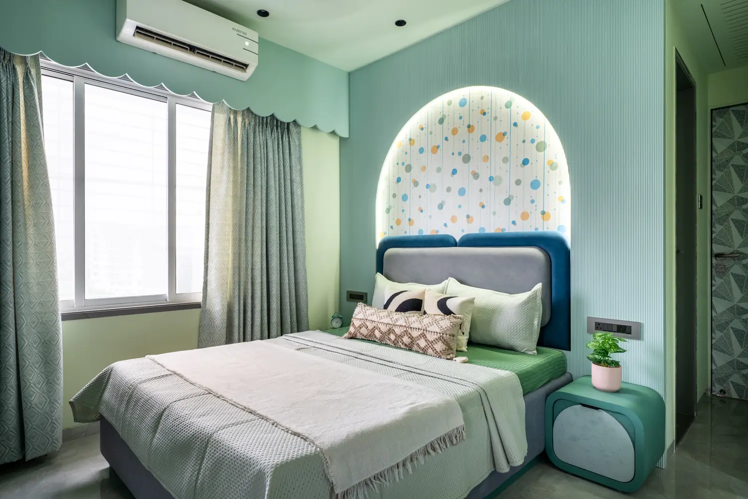 Kids room with a green bed and arched headboard